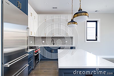 A modern kitchen with blue and white cabinets. Editorial Stock Photo