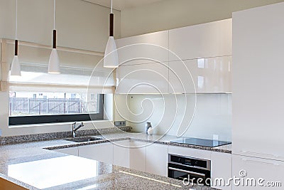 Modern kitchen design in light interior with wood accents. Stock Photo