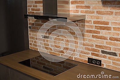 Modern kitchen with electric oven, electic stove and exhauster kitchen fan or range hood Stock Photo