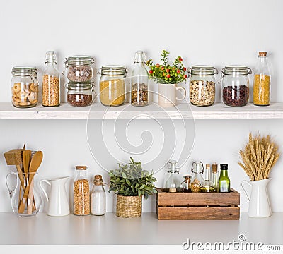 Modern kitchen shelves with various food ingredients on white background Stock Photo