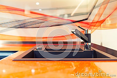 Modern kitchen sink in orange ceramic Stock Photo