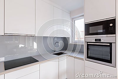 Modern kitchen with white cupboards Stock Photo