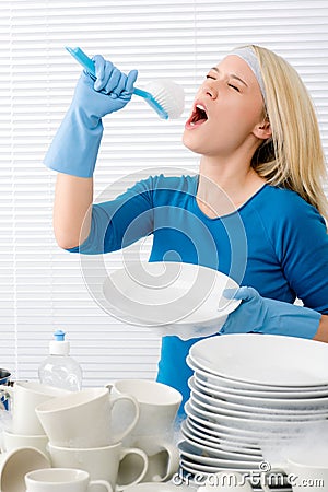 Modern kitchen - woman pretend to sing song Stock Photo