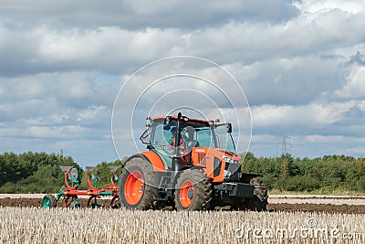 Modern Kubota tractor pulling a plough Editorial Stock Photo