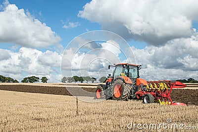 Modern Kubota tractor pulling a plough Editorial Stock Photo