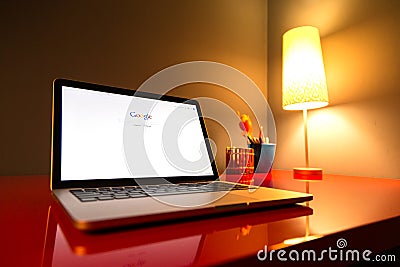 Modern laptop closeup on red modern desk Editorial Stock Photo