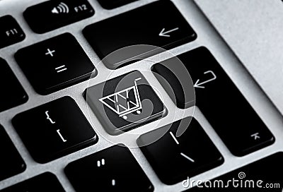 Modern laptop keyboard with cart symbol, closeup. Internet shopping Stock Photo