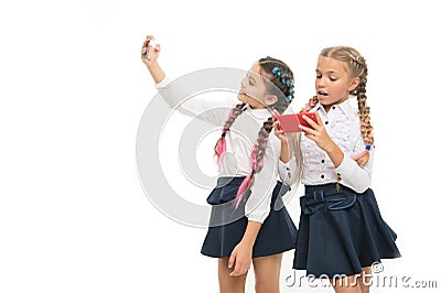 Modern life. Schoolgirls use mobile internet smartphone. School application smartphone. Mobile addiction. Worldwide net Stock Photo