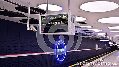 A modern live departure train board above a Warsaw metro line 2 platform. Departure sign in Warszawa Mlynow metro train station. Editorial Stock Photo