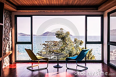 Modern living room with colorful chair with ocean view floor to Editorial Stock Photo