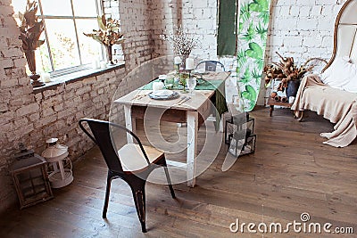 Modern loft living room with high ceiling, sofa, empty white brick wall, wood floor, design accessories, dining table Stock Photo