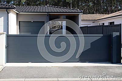 modern long grey sliding style gate aluminum home portal gray slide house entrance Stock Photo