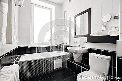 Modern luxury bathroom with bathtub and window. Interior design. Stock Photo