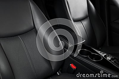 Modern luxury car black leather interior. Part of leather car seat details with stitching. Interior of prestige modern car. Comfor Stock Photo