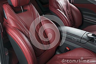 Modern Luxury car inside. Interior of prestige modern car. Comfortable leather red seats. Red perforated leather cockpit Stock Photo