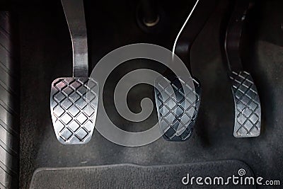 Modern luxury car interior element metal gas clutch and brake pedal. Sport car with manual gearbox controls Stock Photo