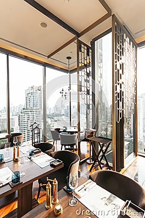 Modern luxury decorated interior restaurant that can view Bangkok cityscape. Elegant design for fine dining Editorial Stock Photo