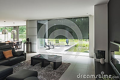 Modern luxury villa interior, open door, gadern, swimming pool. Stock Photo