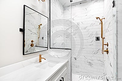 A modern, luxury white bathroom with gold hardware. Editorial Stock Photo