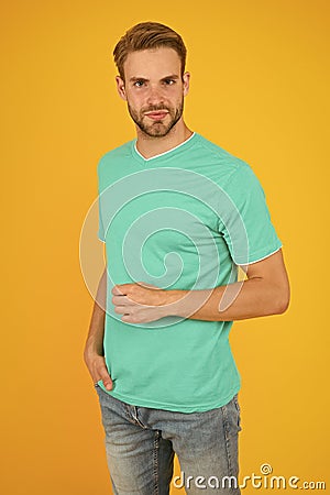 Modern male hairstyle. Hairstyle for hipster. Handsome man yellow background. Well groomed guy with bristle and stylish Stock Photo