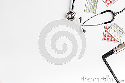 Modern medicine workplace with board, pills, stethoscope white table flat lay space for text Stock Photo