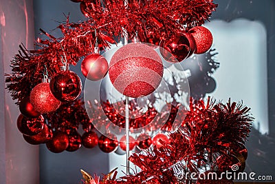 Modern metal spiral Christmas tree decorated with red shiny balls Stock Photo