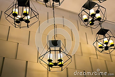 Modern metallic stylish hang ceiling lamps with beautiful wall background Stock Photo