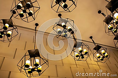 Modern metallic stylish hang ceiling lamps with beautiful wall background Stock Photo