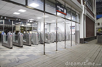 Modern metallic turnstile gate, entrance of railway station. Moscow, Russia Editorial Stock Photo