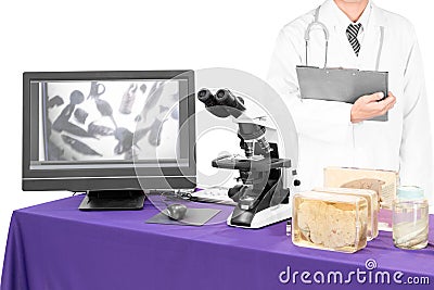 Modern microscope with a doctor with liver fluke Stock Photo