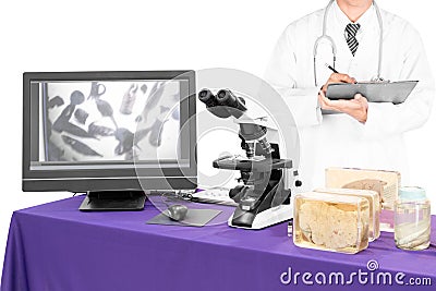 Modern microscope with a doctor with liver fluke Stock Photo