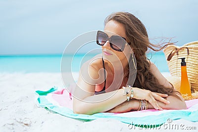 Modern middle age woman looking into distance and sun bathing Stock Photo