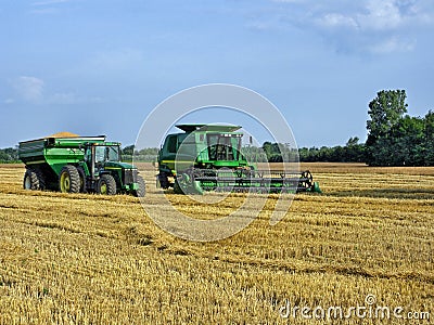 Green Farm Equipment in Midwest Field Editorial Stock Photo