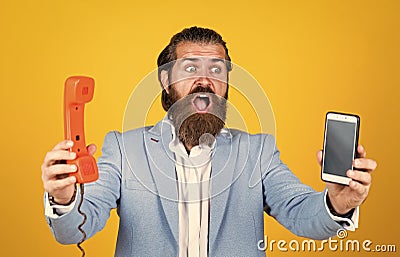 Modern mobile phone and old vintage classic telephone. Technology is advancing all the time. live in Digital Age Stock Photo