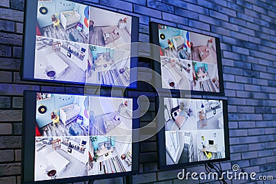 Modern monitors with video broadcasting from security cameras indoors Stock Photo