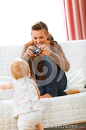 Modern mother making photos of baby Stock Photo