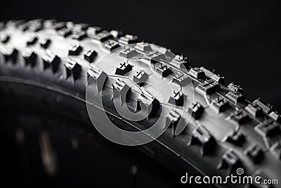 Modern MTB race mountain bike tyre isolated on black background Stock Photo