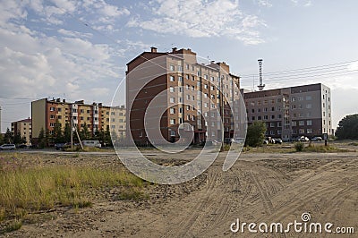 Modern multi-storeyed buildings with telecommunications tower behind Stock Photo