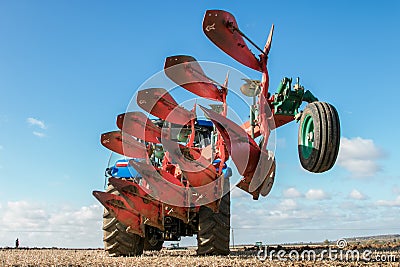 Modern new holland tractor pulling a plough Editorial Stock Photo