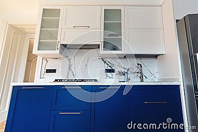 Modern new kitchen with sink, worktop and simple cupboards Stock Photo