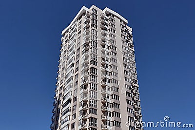 Modern new residential concrete high-rises on a background of the sky. Front view part of multi-storey new built. Stock Photo