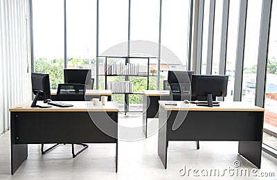 Modern office interior design with table, computer, monitor, big glass window around the room Stock Photo