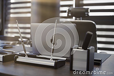 Modern office workplace. Business laptop in work place for chief, boss or other employees. Notebook on work table. Light through Editorial Stock Photo
