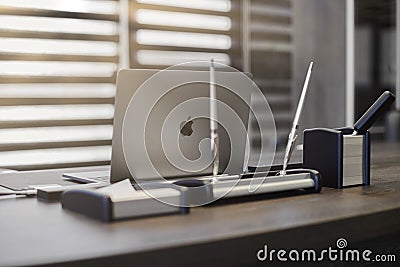 Modern office workplace. Business laptop in work place for chief, boss or other employees. Notebook on work table. Light through Editorial Stock Photo