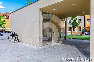 Modern outdoor public toilet combined with bus stop, Regensburg, Germany Editorial Stock Photo