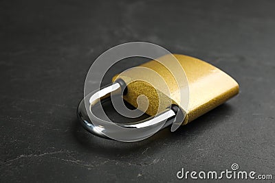 Modern padlock on black table, closeup. Safety and protection Stock Photo