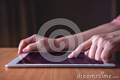 Modern Person Using Digital Tablet on Wooden Table Stock Photo