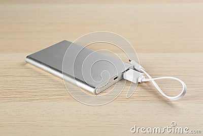 Modern portable charger with cable on background Stock Photo