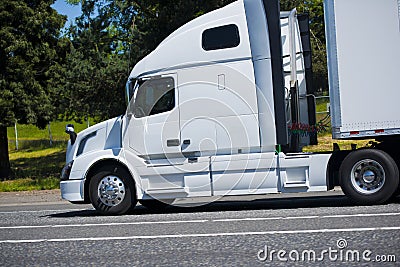 Modern powerful leader semi truck profile white nice road Stock Photo