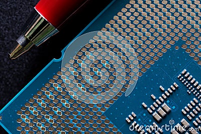 Modern powerful multi-core personal computer processor compared to the tip of a fountain pen. Black background. Computer assembly Stock Photo